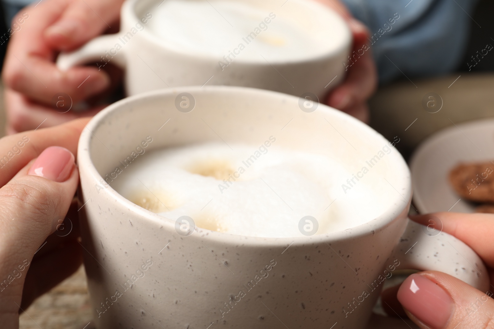 Photo of Women having coffee break at table, closeup