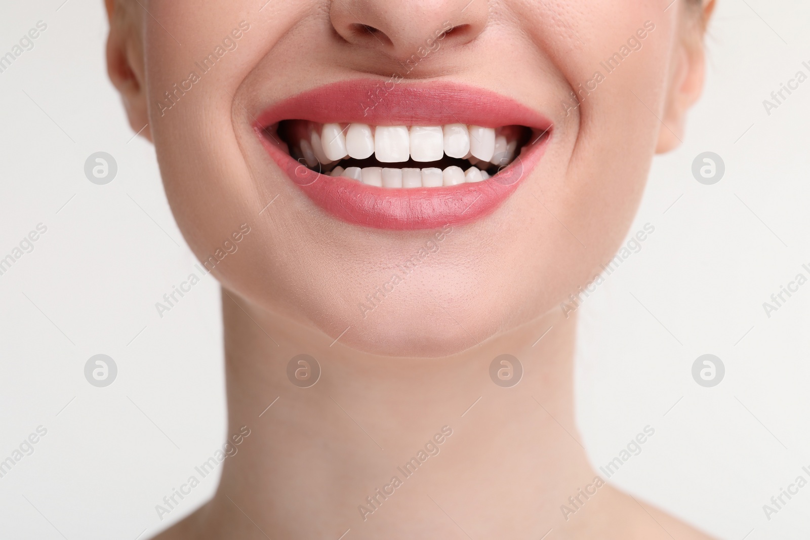 Photo of Young woman with beautiful smile on white background, closeup