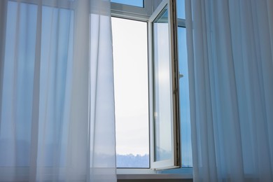 Open window and elegant white curtains indoors. Interior design