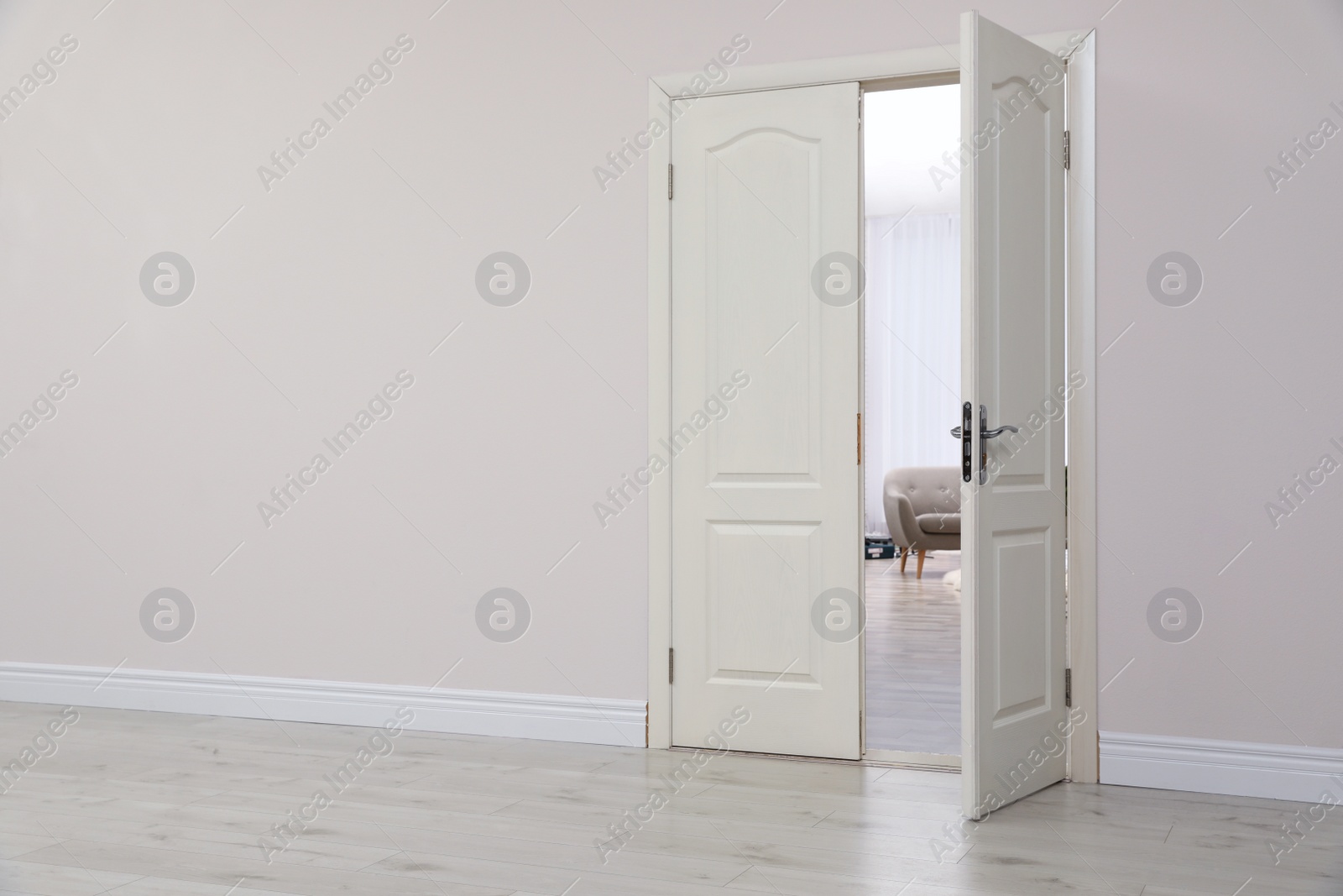 Photo of Stylish room interior, view through open door. Space for text