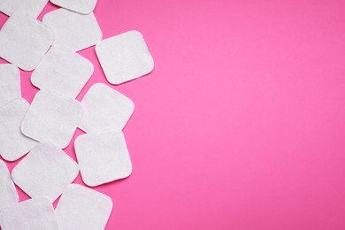 Photo of Many cotton pads on pink background, flat lay. Space for text