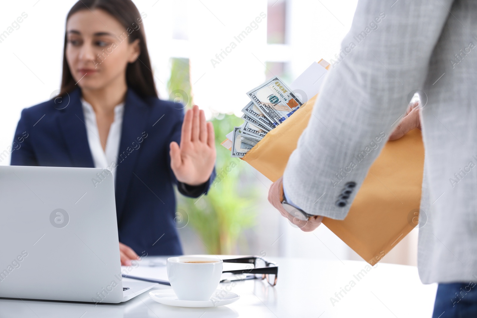 Photo of Businesswoman rejecting bribe at table in office, closeup