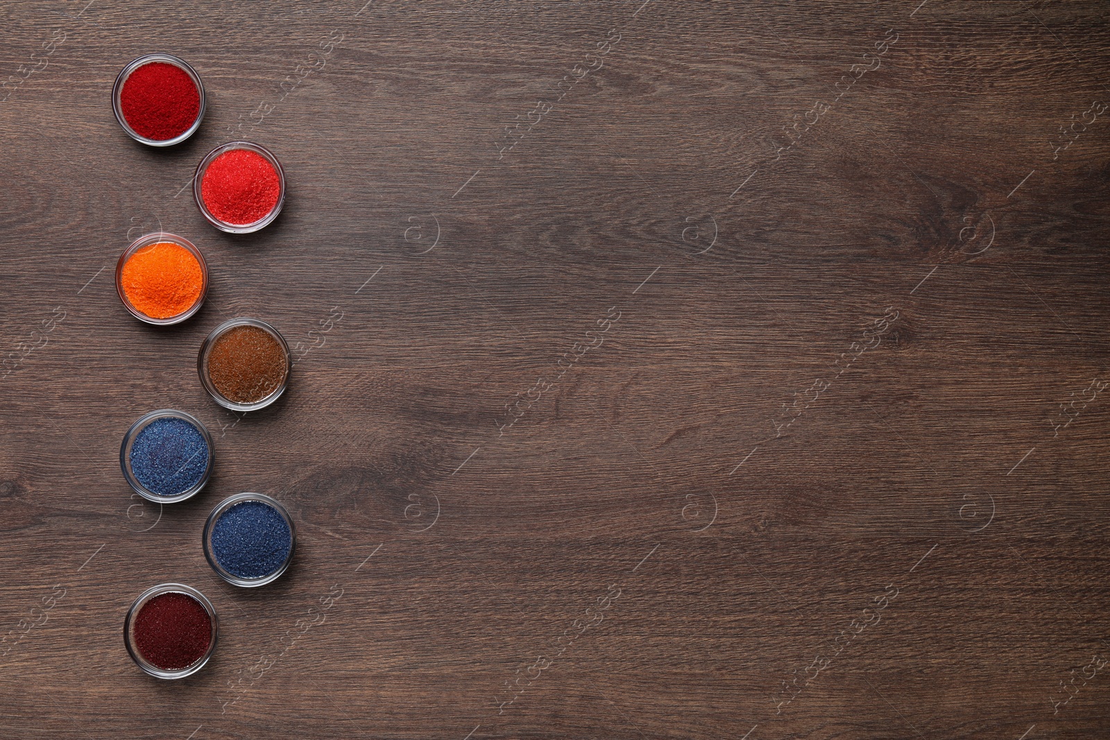 Photo of Many different food coloring on wooden table, flat lay. Space for text