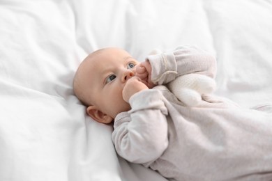 Cute little baby lying on white sheets