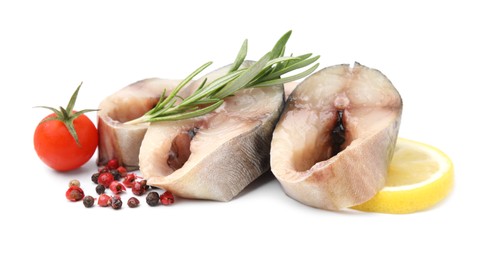 Pieces of mackerel fish with cherry tomato, rosemary, lemon and spices on white background