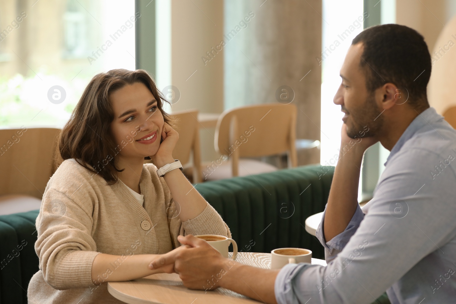 Photo of Romantic date. Happy couple spending time together in cafe