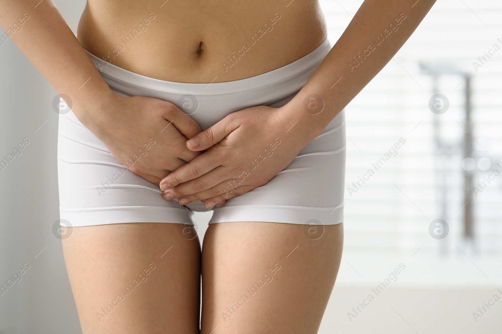 Photo of Woman suffering from cystitis at home, closeup