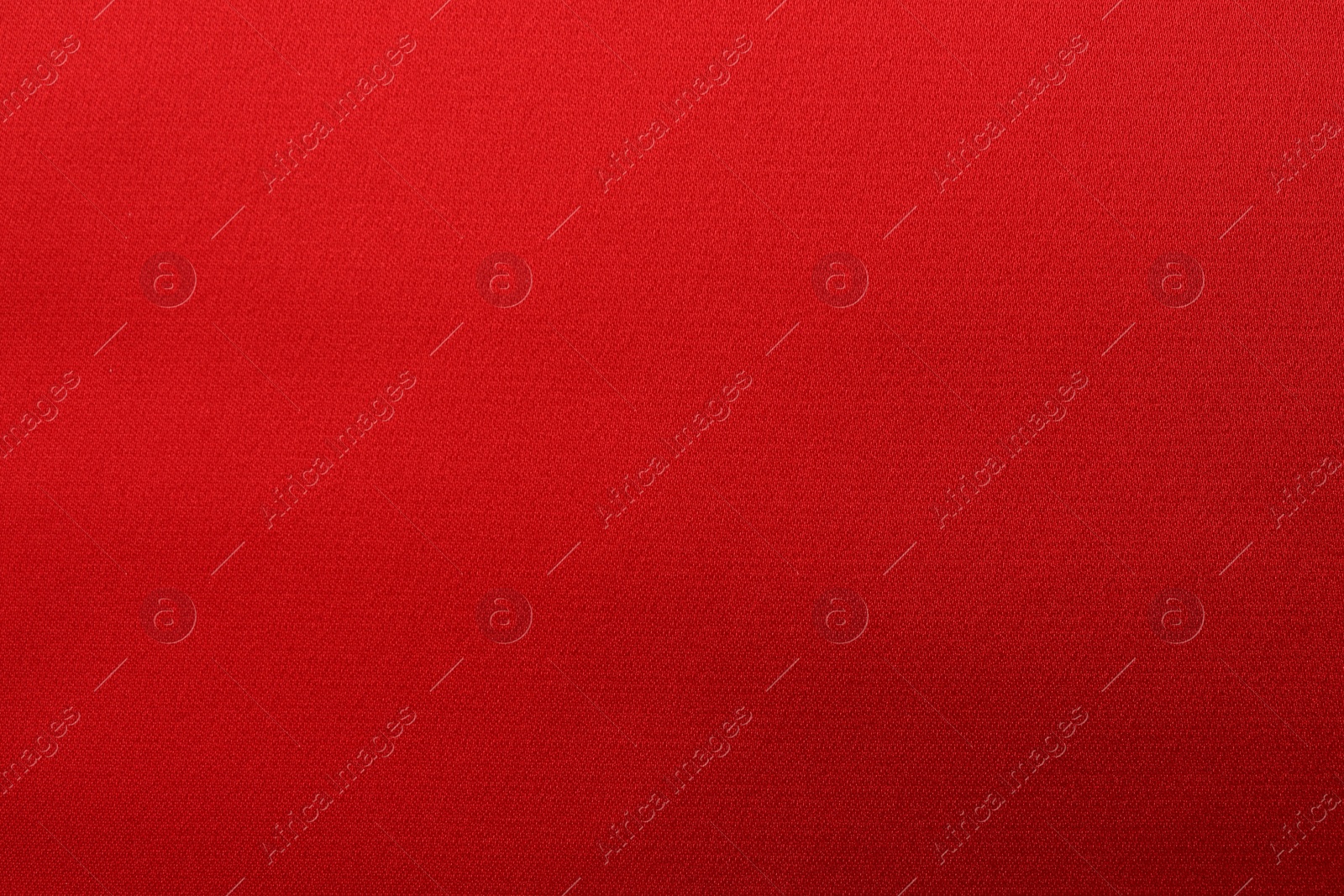 Photo of Texture of red silk fabric as background, top view