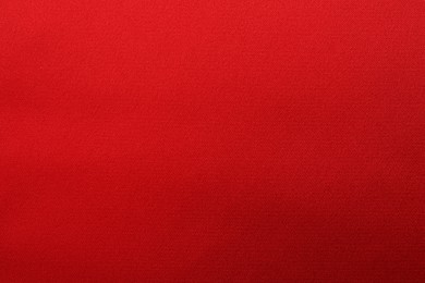 Texture of red silk fabric as background, top view