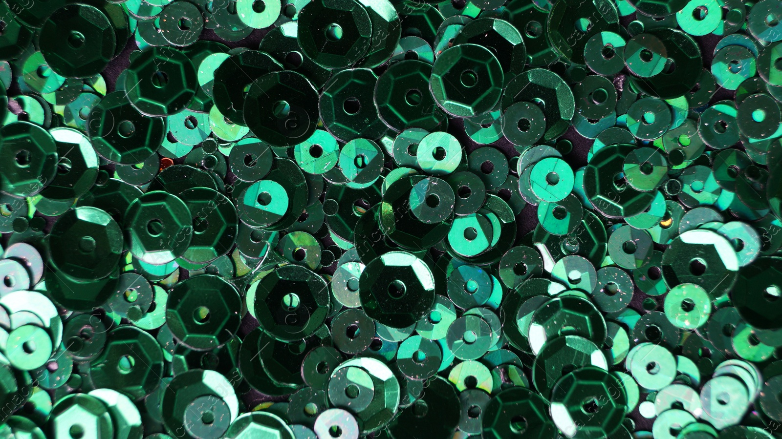 Photo of Many beautiful green sequins as background, closeup