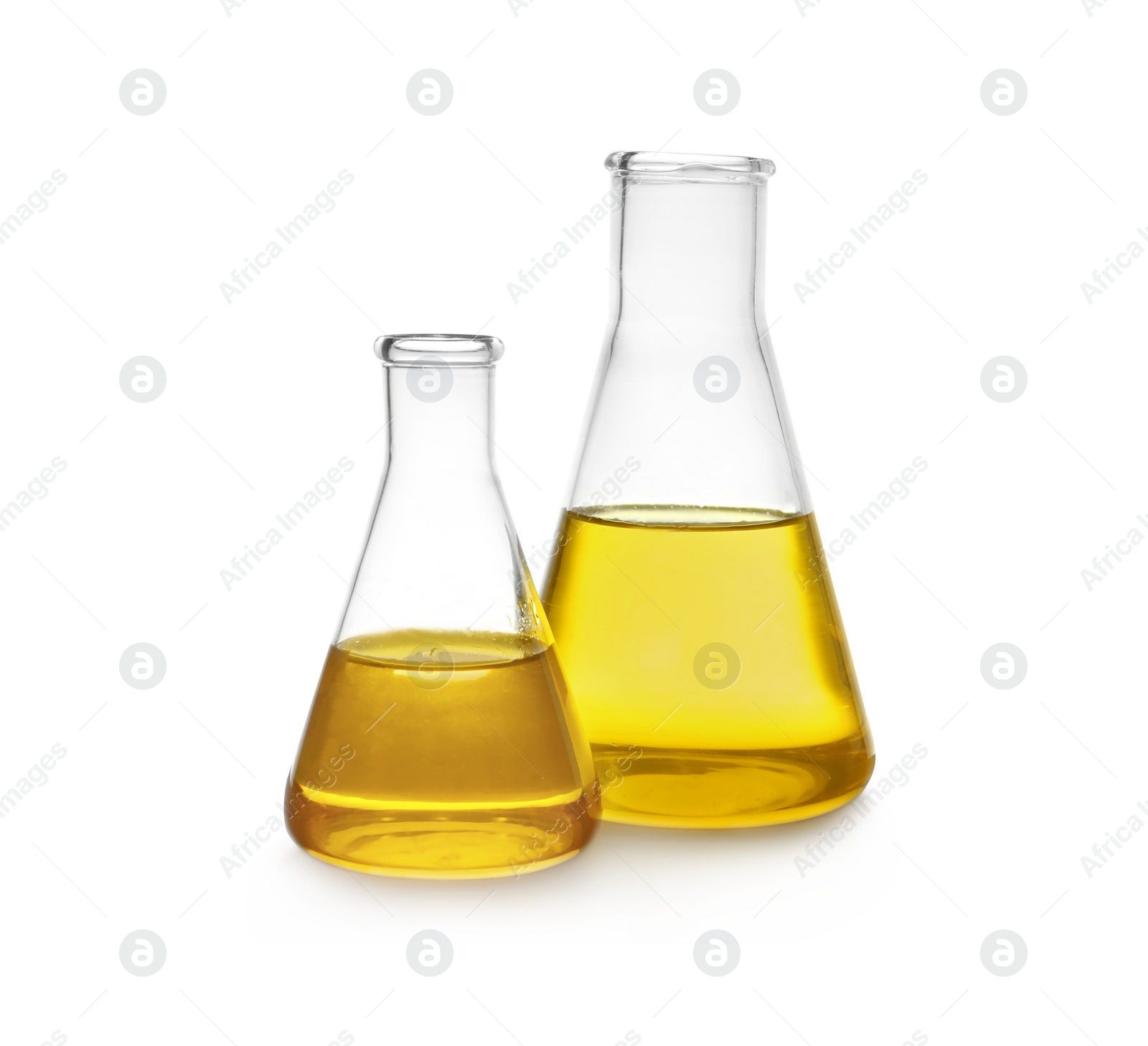 Photo of Conical flasks with yellow liquid on white background