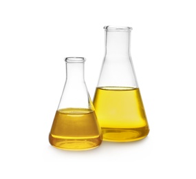 Photo of Conical flasks with yellow liquid on white background