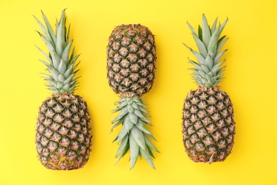 Photo of Fresh pineapples on color background, flat lay