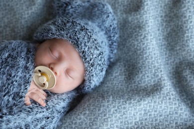 Photo of Cute newborn baby sleeping on blanket, top view. Space for text