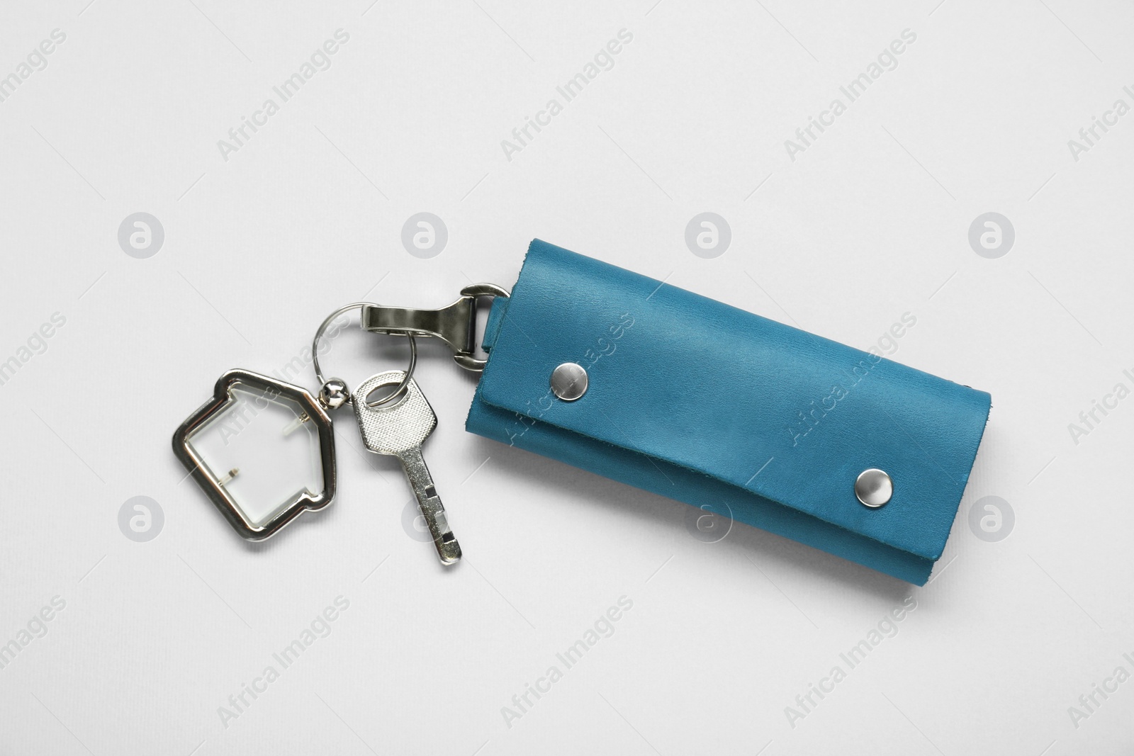 Photo of Leather case with key on light grey background, top view