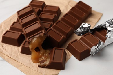 Tasty chocolate bars on white table, closeup