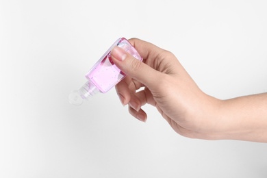 Photo of Woman holding antiseptic gel on white background, closeup