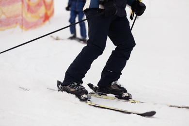 Skier on slope at resort, closeup. Winter vacation