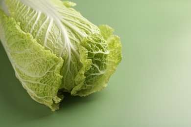 Fresh ripe Chinese cabbage on pale green background, closeup. Space for text