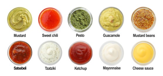 Image of Set of different sauces in bowls and names isolated on white, top view