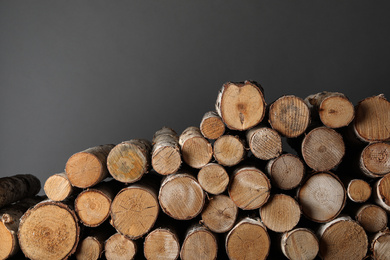 Photo of Cut firewood on grey background. Heating in winter