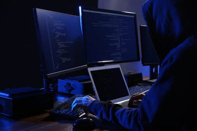 Hacker with computers in dark room. Cyber crime