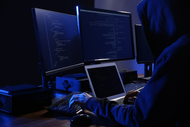 Photo of Hacker with computers in dark room. Cyber crime