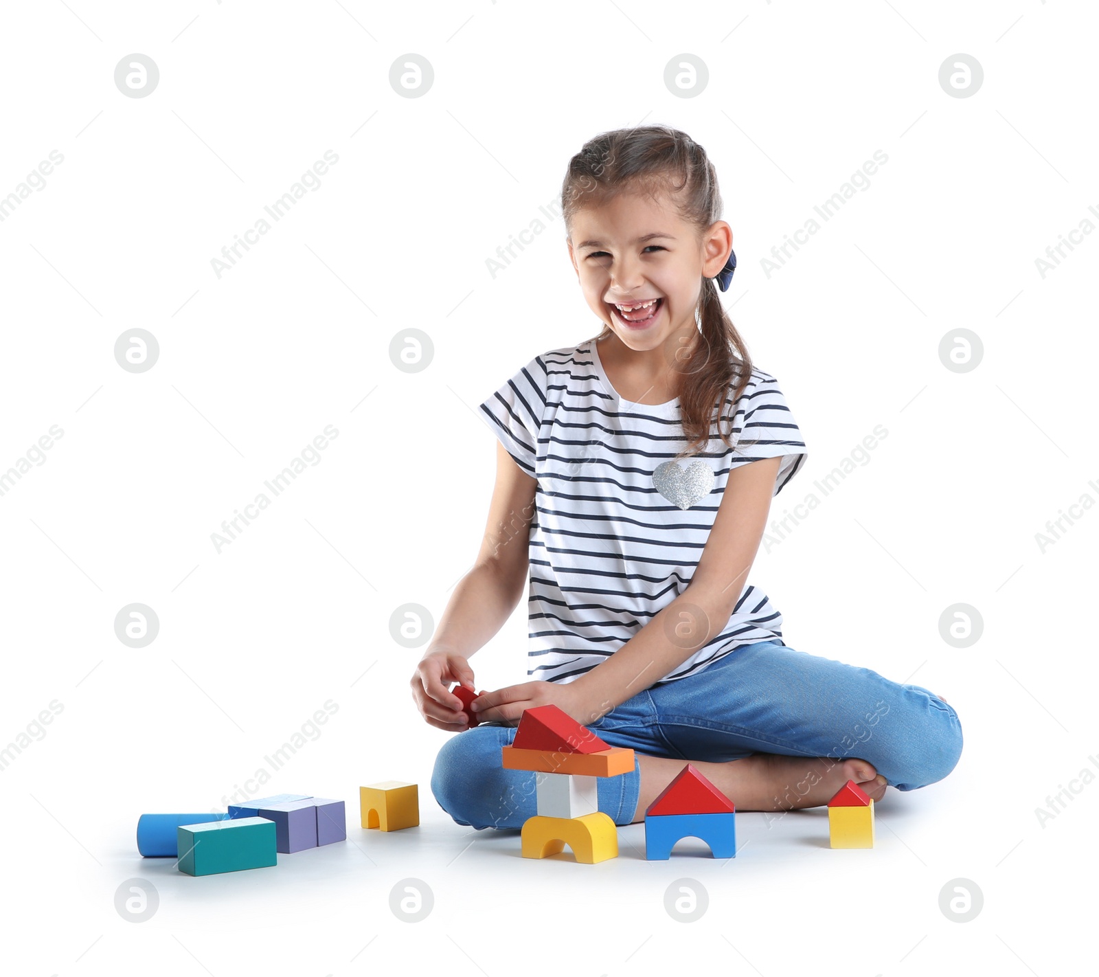 Photo of Cute child playing with colorful blocks on white background