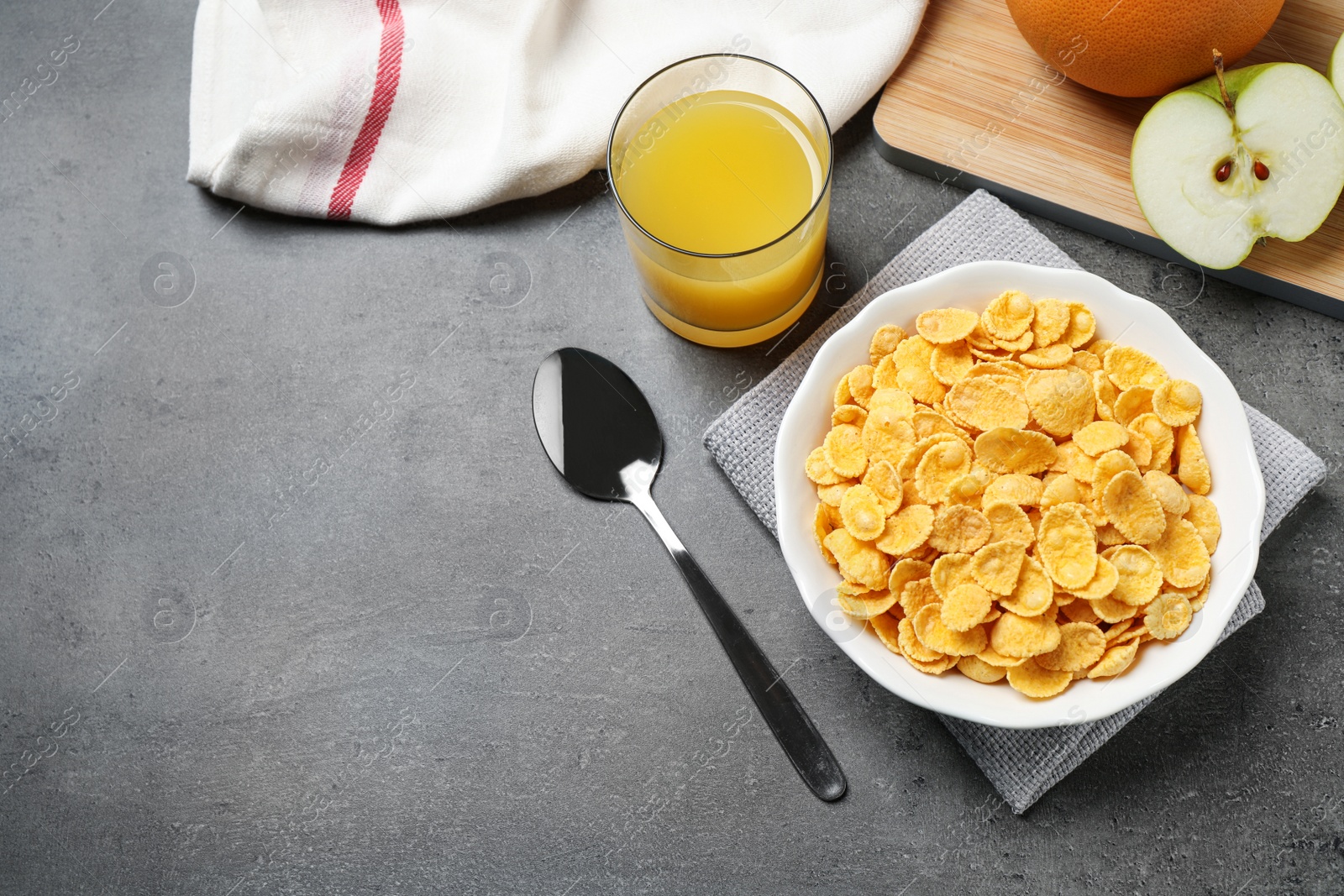 Photo of Flat lay composition with tasty corn flakes on grey table, space for text