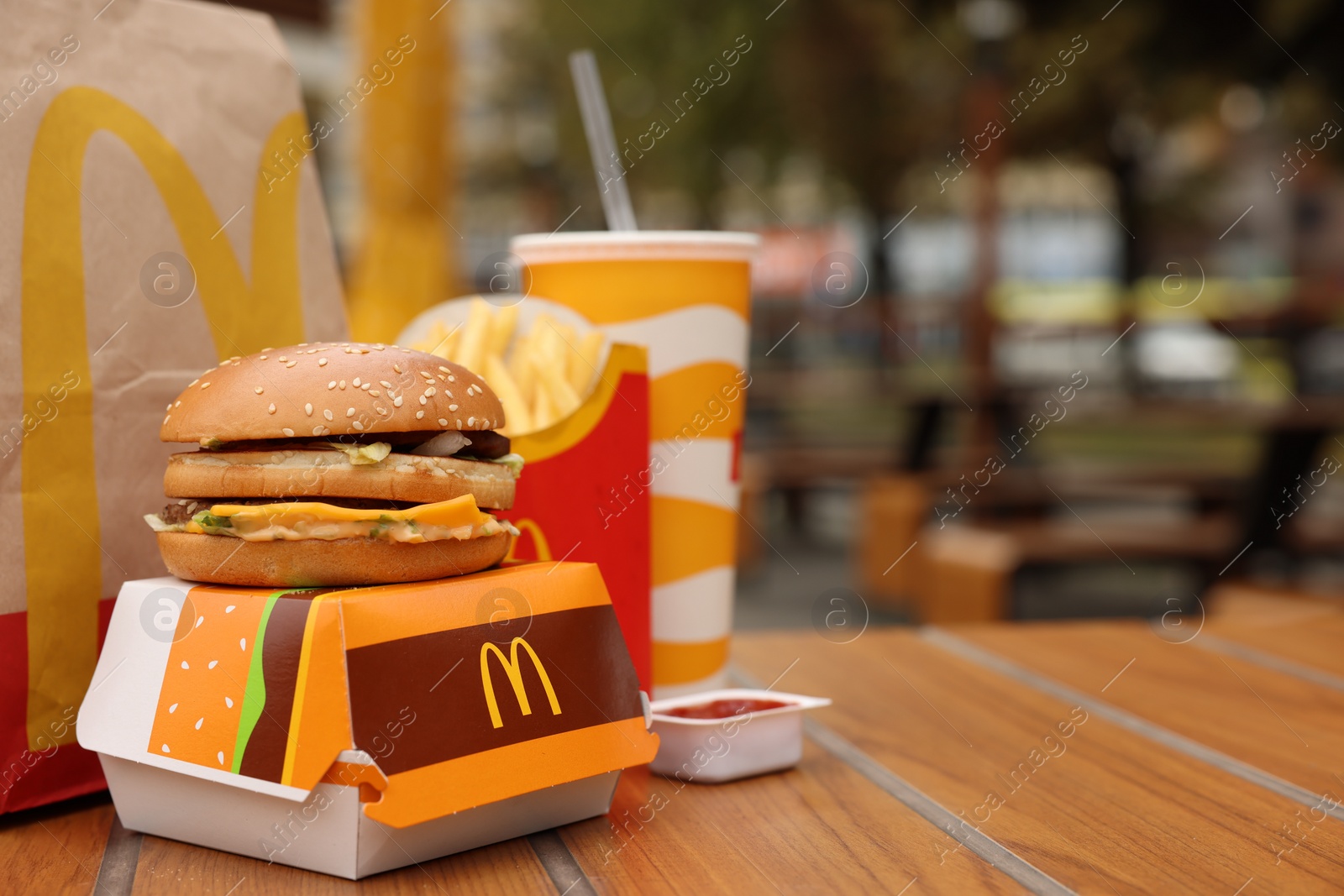 Photo of Lviv, Ukraine - October 9, 2023: McDonald's menu on wooden table outdoors, space for text