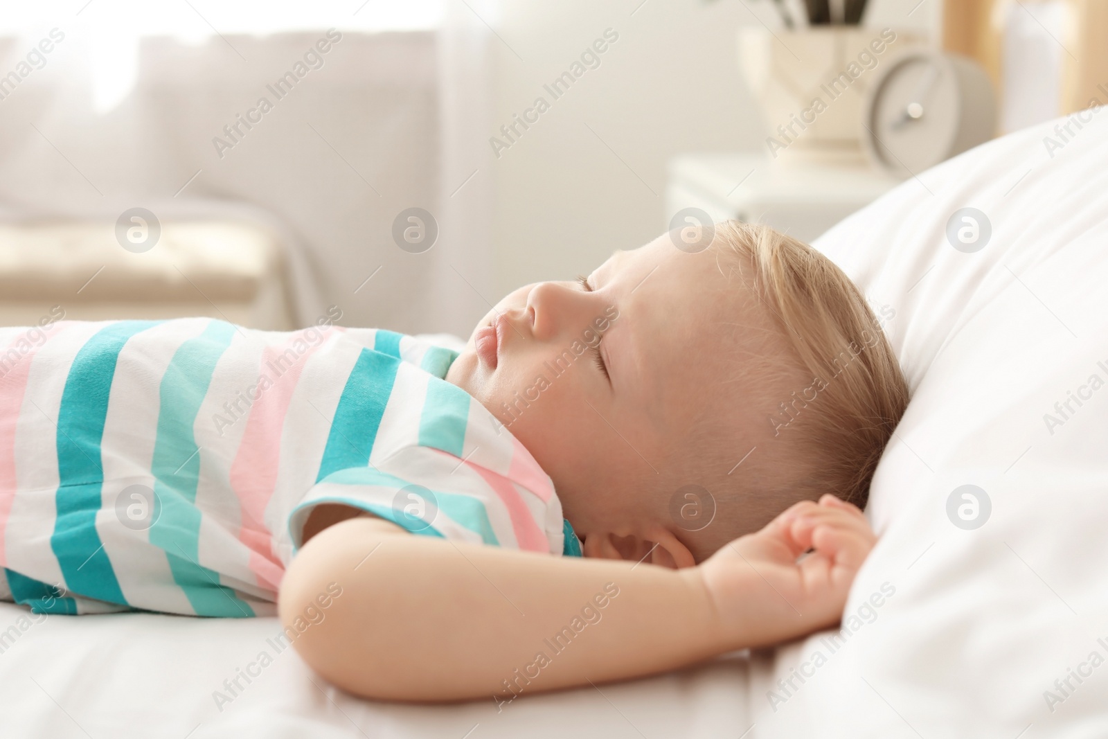 Photo of Little child sleeping on bed at home