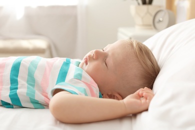 Photo of Little child sleeping on bed at home
