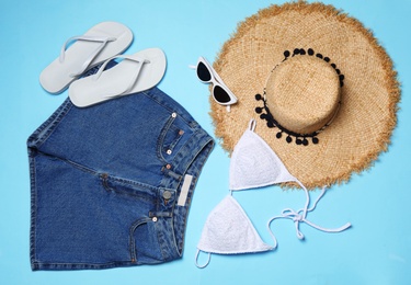 Flat lay composition with stylish bikini on color background. Beach objects