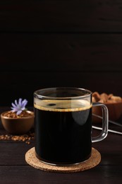 Glass cup of delicious chicory drink on wooden table