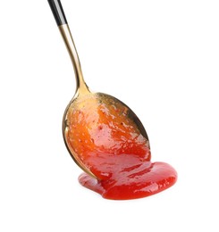 Photo of Spreading tasty ketchup with spoon on white background. Tomato sauce