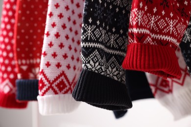 Closeup view of many different Christmas sweaters
