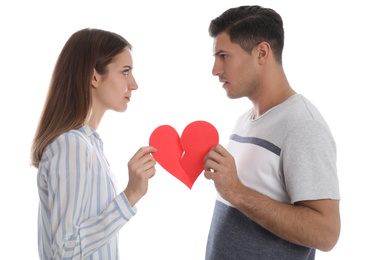 Photo of Couple tearing paper heart on white background. Relationship problems