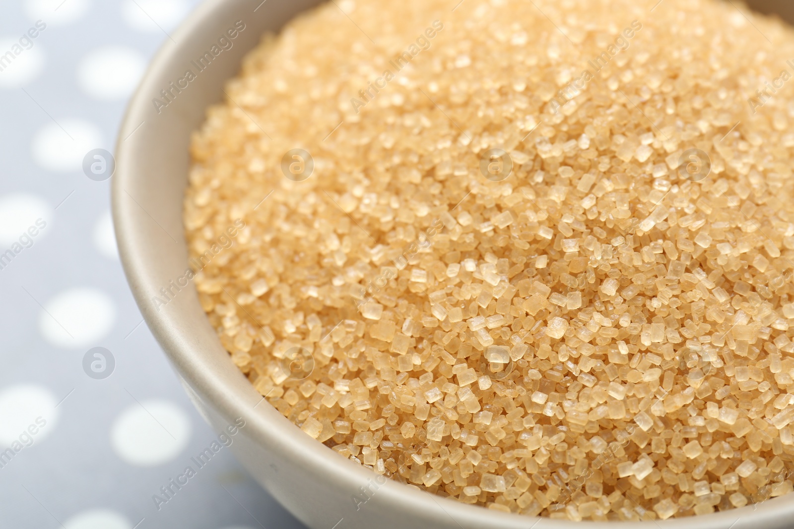 Photo of Brown sugar in bowl on table, closeup