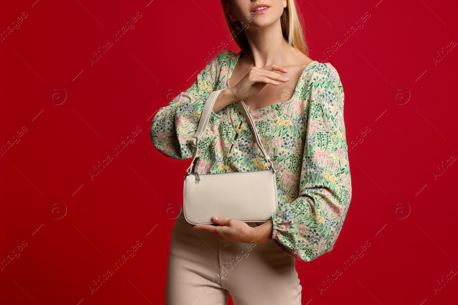 Photo of Stylish woman with trendy baguette bag on red background, closeup