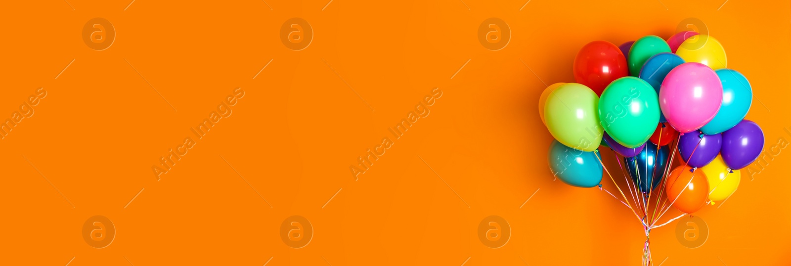 Image of Bunch of bright balloons on orange background, space for text. Banner design 