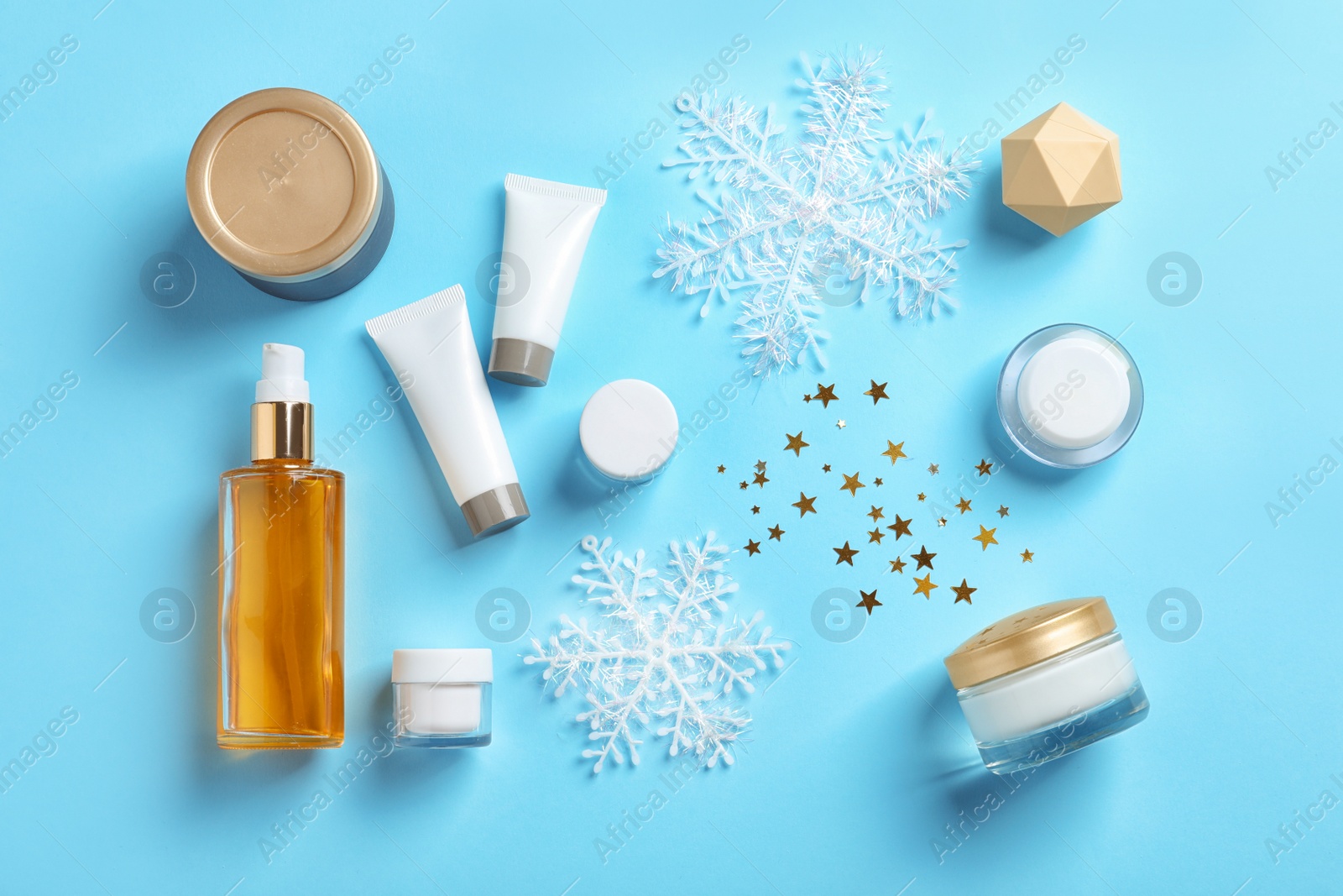 Photo of Set of cosmetic products on blue background, flat lay. Winter care