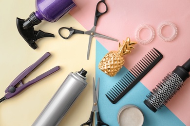 Photo of Flat lay composition with professional hairdresser tools on color background