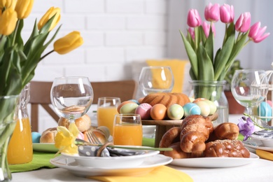 Photo of Festive Easter table setting with traditional meal at home