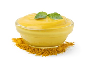 Bowl with tasty curry sauce, powder and basil isolated on white