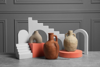 Photo of Clay flagons and other decorative elements on grey table