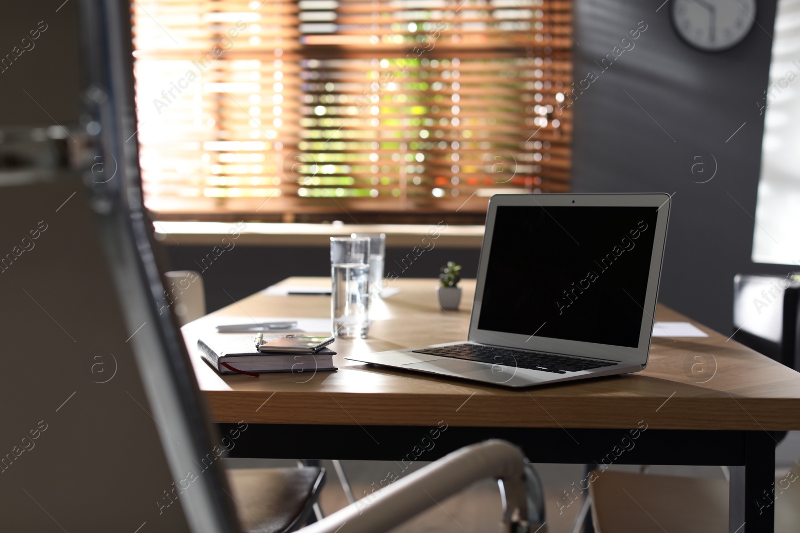 Photo of Laptop on wooden table in modern office