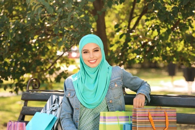Photo of Muslim woman sitting on bench in park