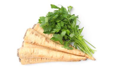 Raw parsley roots and bunch of fresh herb isolated on white, top view