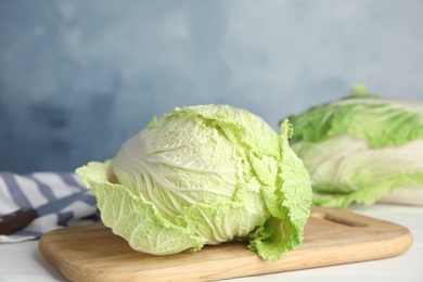Photo of Fresh ripe Chinese cabbage on white wooden table