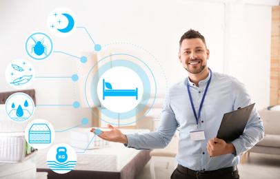 Image of Happy salesman with clipboard in mattress store